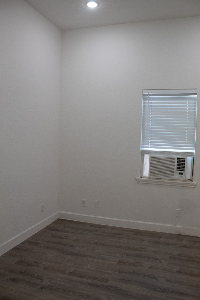 unfurnished room with recessed lighting, dark wood-style floors, baseboards, and cooling unit