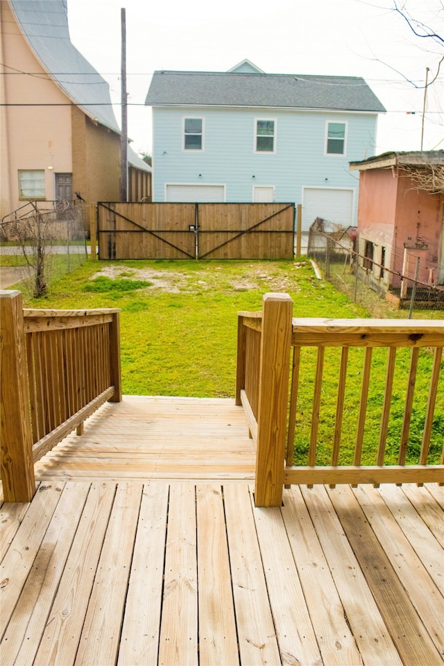 deck featuring a yard and a fenced backyard