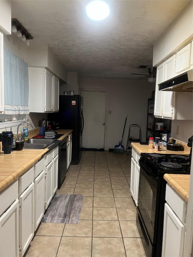 kitchen featuring a ceiling fan, light tile patterned flooring, black appliances, under cabinet range hood, and white cabinetry