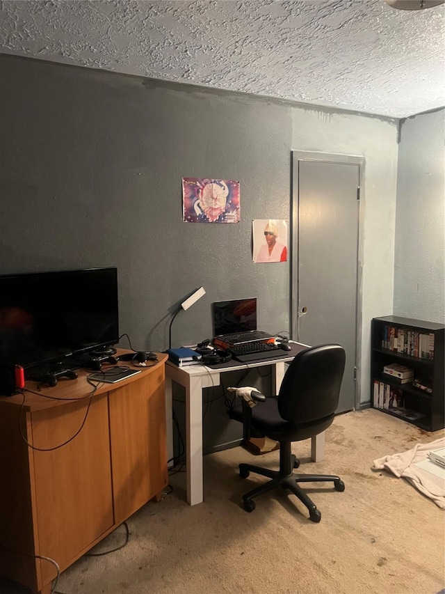 home office featuring a textured ceiling, light colored carpet, and a textured wall