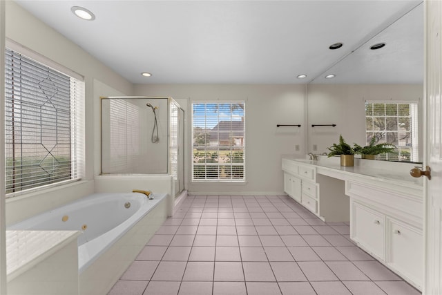 bathroom featuring double vanity, a sink, tile patterned flooring, a shower stall, and a jetted tub