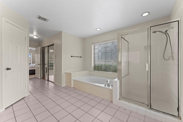 ensuite bathroom with tile patterned floors, a shower stall, a bath, and ensuite bathroom