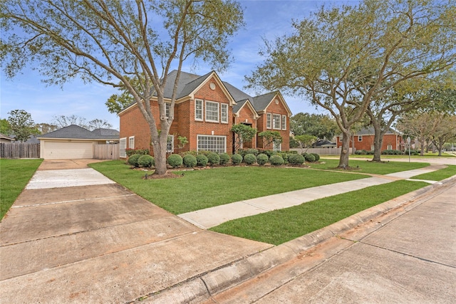 view of front facade with brick siding, a front yard, and fence