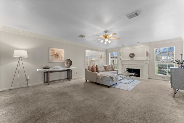 living room featuring visible vents, ornamental molding, a fireplace, carpet flooring, and baseboards