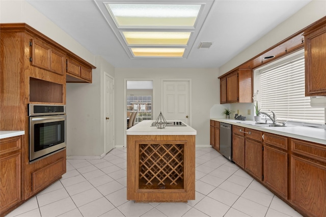 kitchen with a sink, stainless steel appliances, and light countertops