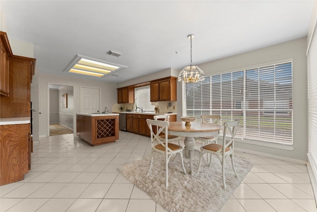 dining area featuring an inviting chandelier, light tile patterned flooring, baseboards, and visible vents