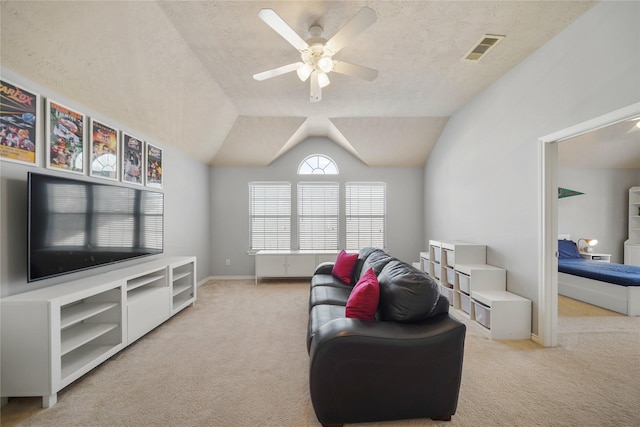 sitting room featuring visible vents, lofted ceiling, ceiling fan, a textured ceiling, and carpet flooring