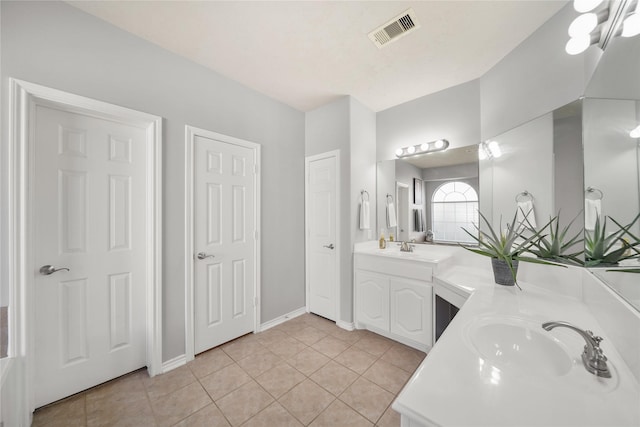 full bathroom with double vanity, visible vents, a sink, and tile patterned flooring