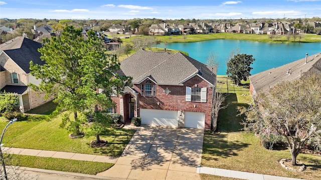 birds eye view of property featuring a residential view and a water view