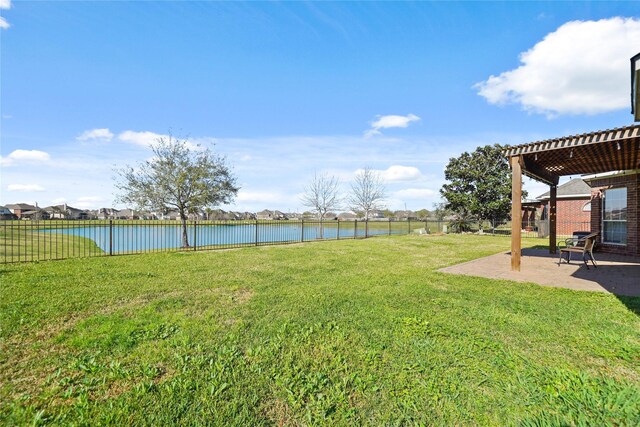 view of yard with a patio area, a pergola, and a water view