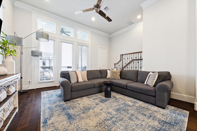 living area with visible vents, dark wood-style flooring, baseboards, and ornamental molding