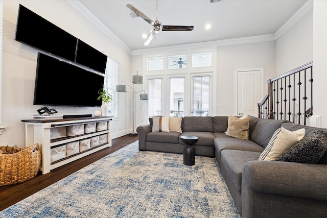 living area featuring baseboards, stairway, ornamental molding, wood finished floors, and a ceiling fan