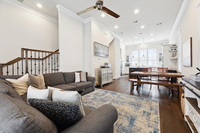 living area with dark wood finished floors, stairs, and visible vents