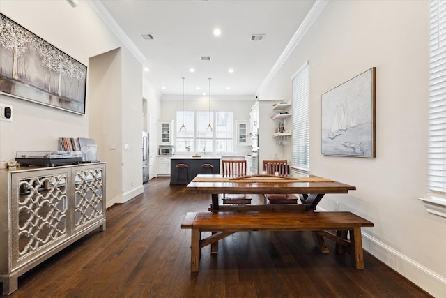 dining space with visible vents, baseboards, ornamental molding, and dark wood-style flooring