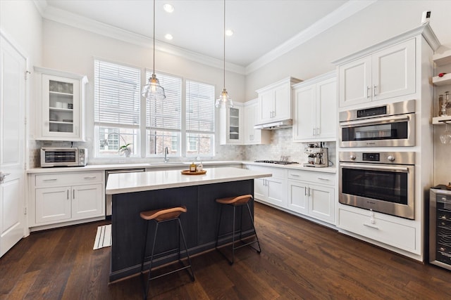 kitchen featuring double oven, white cabinets, light countertops, and gas cooktop