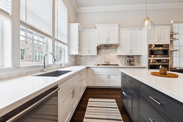 kitchen with a sink, appliances with stainless steel finishes, and white cabinetry