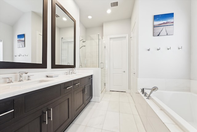 full bath with visible vents, a garden tub, double vanity, a stall shower, and a sink