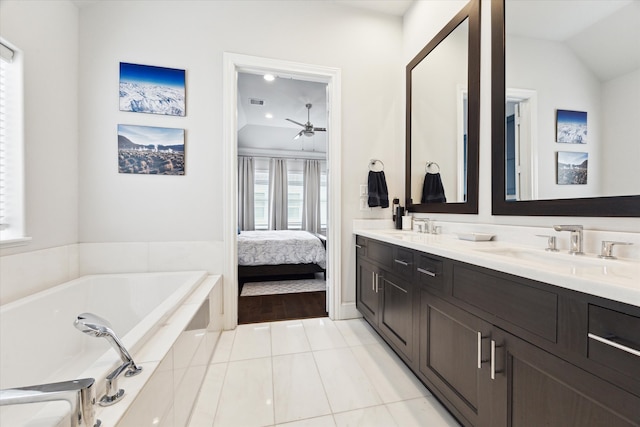 bathroom featuring a sink, lofted ceiling, a bath, and tile patterned floors