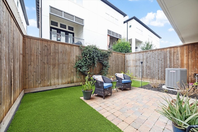 view of patio / terrace with a fenced backyard and central AC