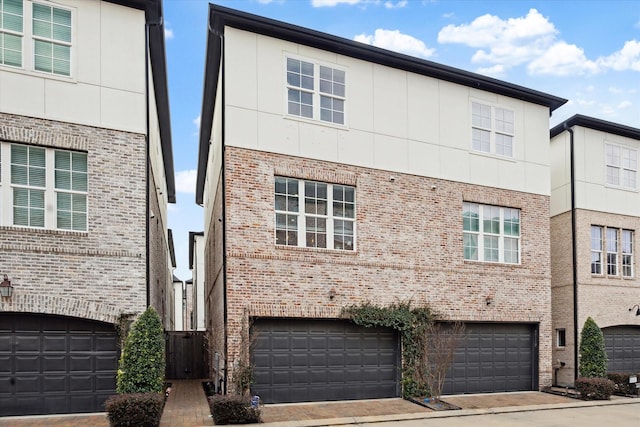 view of property with brick siding and an attached garage