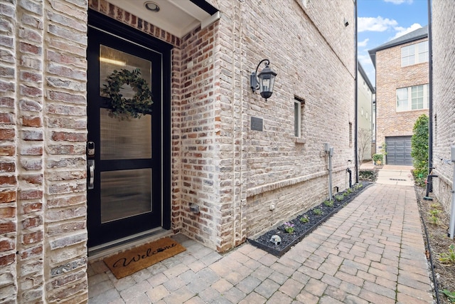 doorway to property featuring brick siding