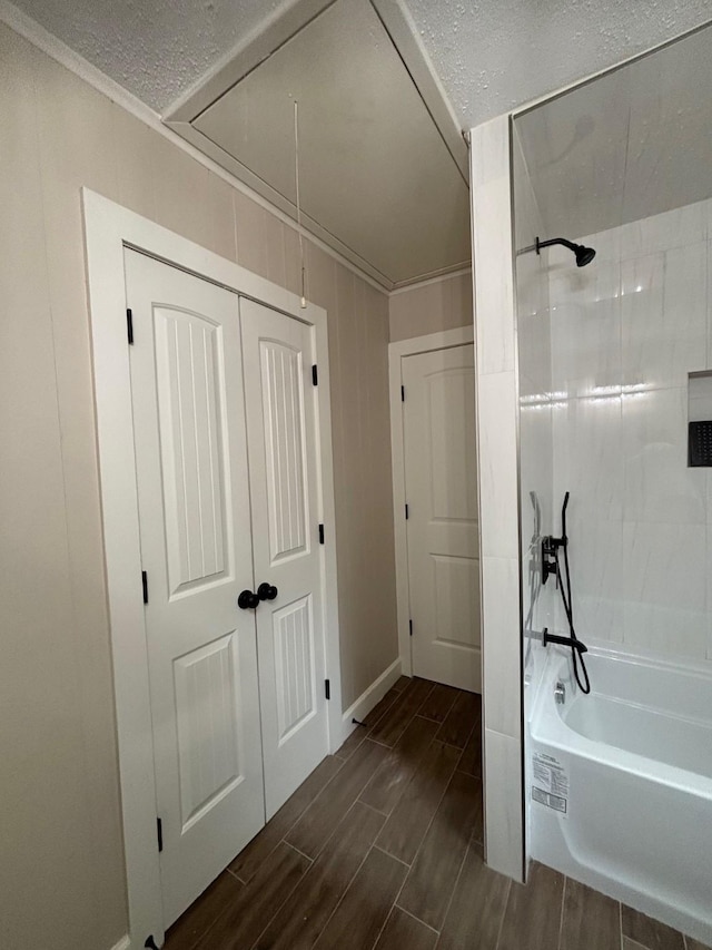 full bathroom featuring tub / shower combination, a textured ceiling, and wood tiled floor