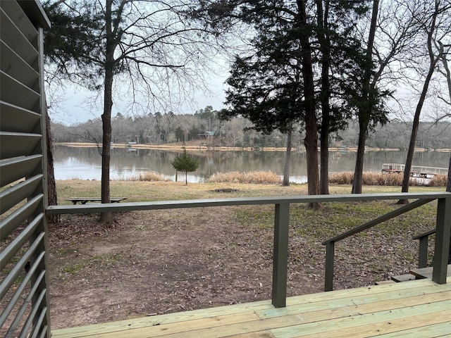 wooden terrace featuring a water view