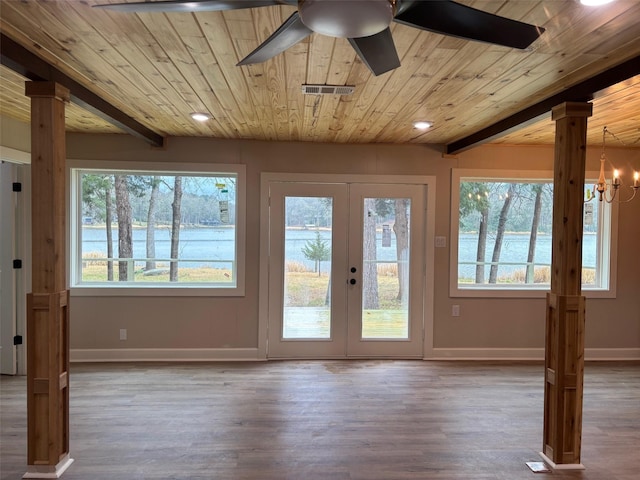 entryway featuring ceiling fan with notable chandelier, decorative columns, visible vents, wood ceiling, and baseboards