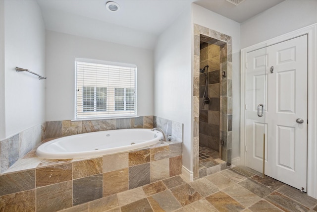 full bathroom with a bath, a stall shower, and stone tile flooring