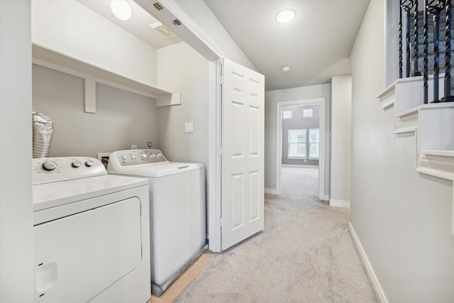 laundry room with visible vents, baseboards, washer and clothes dryer, light carpet, and laundry area