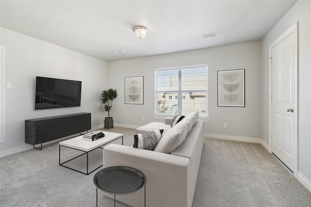 living room with visible vents, light carpet, and baseboards