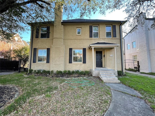 view of front of house with fence, brick siding, and a chimney