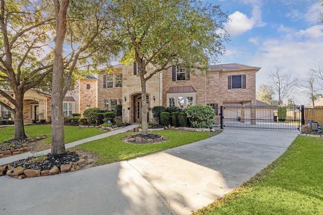 view of front of home featuring a front yard, a gate, fence, driveway, and stone siding