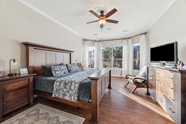 bedroom featuring dark wood-style floors, visible vents, crown molding, and a ceiling fan