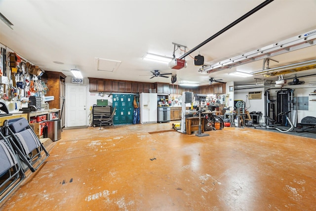 garage with a workshop area, white refrigerator with ice dispenser, a garage door opener, and ceiling fan