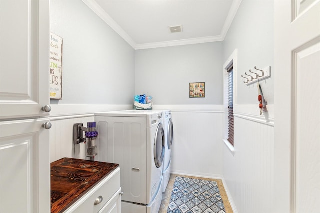 washroom with light tile patterned floors, visible vents, ornamental molding, wainscoting, and washing machine and dryer