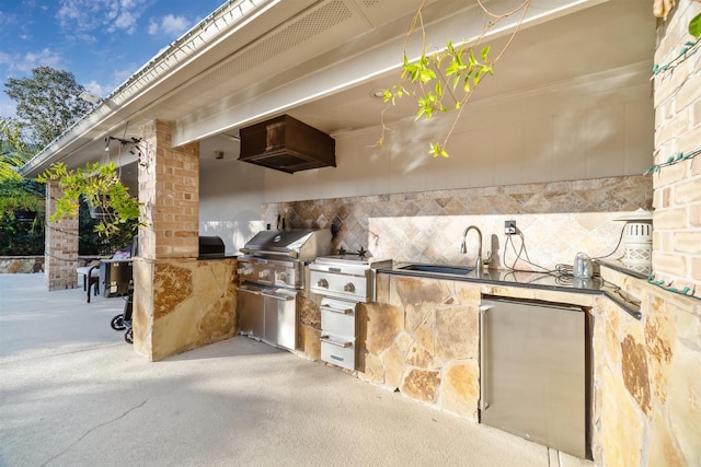 view of patio with area for grilling, exterior kitchen, and a sink