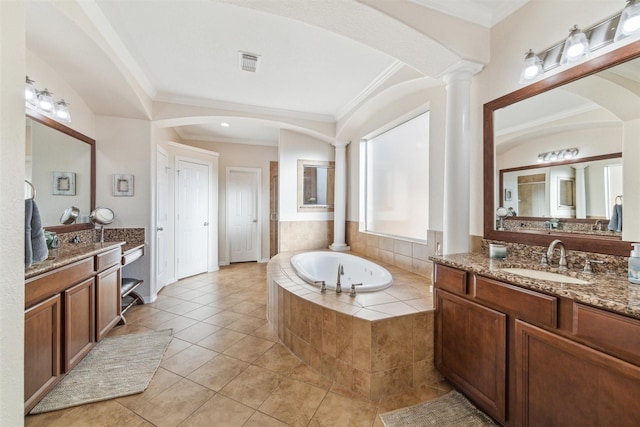 bathroom with a bath, visible vents, ornate columns, and ornamental molding