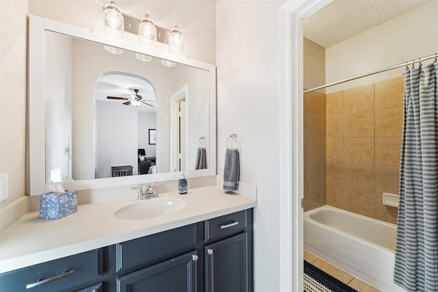 full bath with tile patterned flooring, shower / bath combination with curtain, vanity, and a ceiling fan