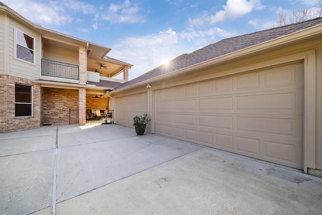 garage featuring concrete driveway and a ceiling fan