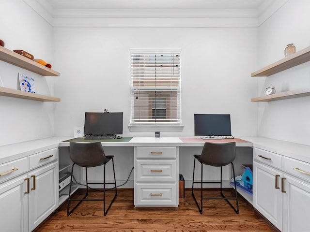 office with ornamental molding, wood finished floors, and built in study area