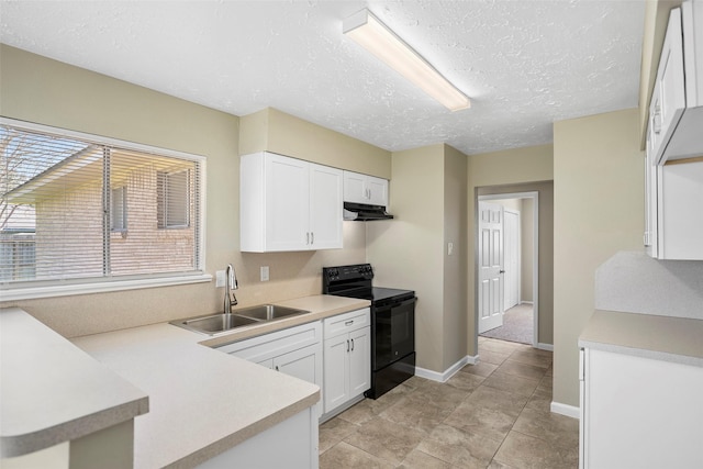 kitchen featuring light countertops, white cabinets, black / electric stove, and a sink