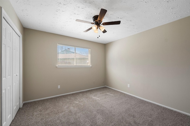 unfurnished bedroom with a closet, baseboards, carpet, and a textured ceiling