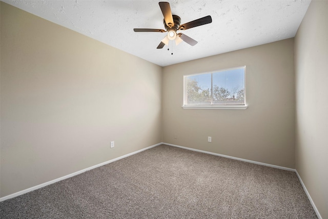 empty room with a ceiling fan, carpet, baseboards, and a textured ceiling