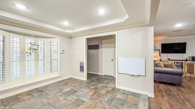 17866 Magnolia Ln, New Caney, TX 77357 - unfurnished room featuring baseboards, stone finish flooring, a raised ceiling, and recessed lighting