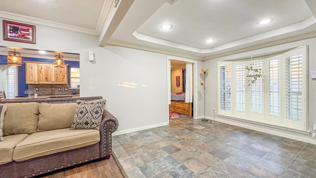 17866 Magnolia Ln, New Caney, TX 77357 - living room featuring baseboards, a tray ceiling, stone finish floors, recessed lighting, and ornamental molding