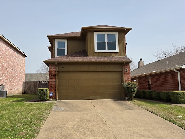 view of front facade featuring a front yard, fence, driveway, a garage, and brick siding