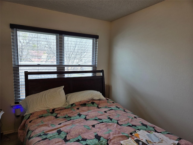 bedroom with multiple windows and a textured ceiling