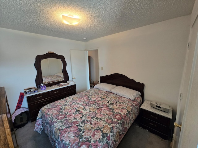 bedroom featuring carpet floors and a textured ceiling