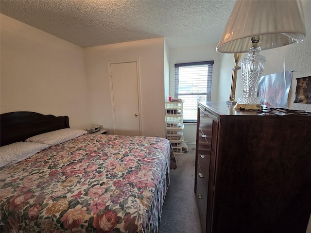 bedroom featuring carpet floors and a textured ceiling